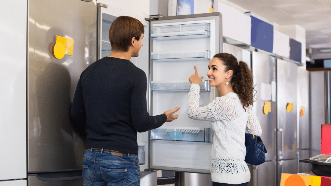 Couple shopping for refrigerators